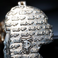 a close up of a pendant with words written on it